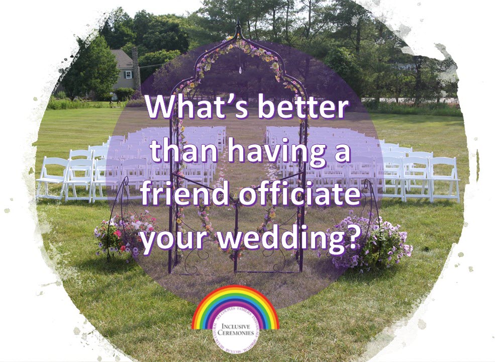 An arch decorated with flowers stands before rows of white chairs in field, set up for a wedding ceremony.